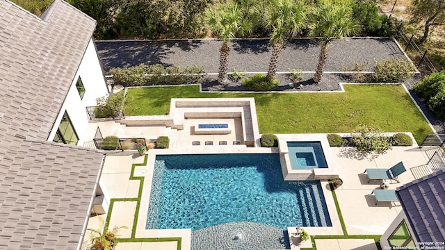 view of swimming pool with a yard