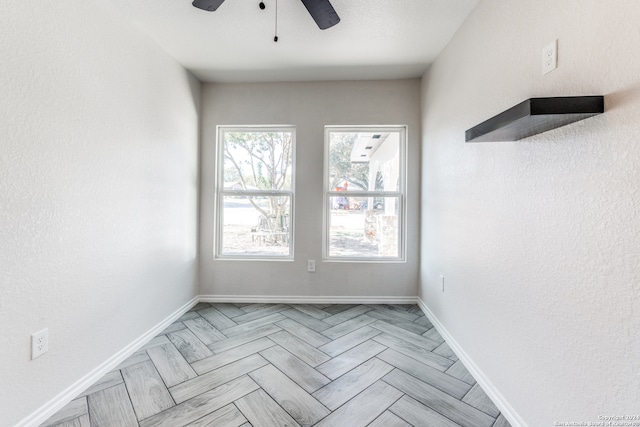 spare room featuring ceiling fan and light parquet flooring