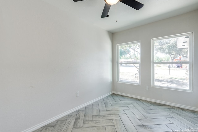 empty room featuring light parquet floors and ceiling fan