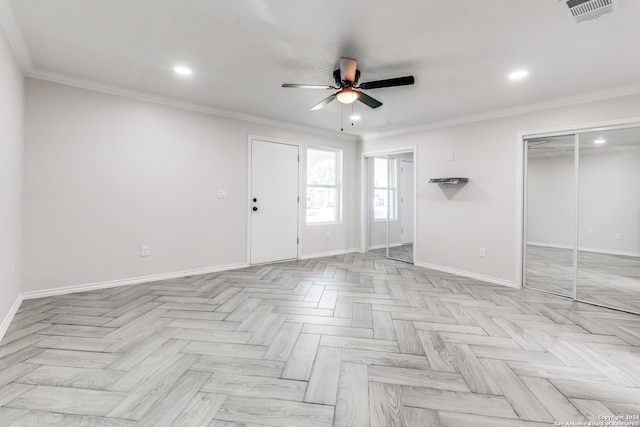 spare room featuring ceiling fan, light parquet floors, and crown molding