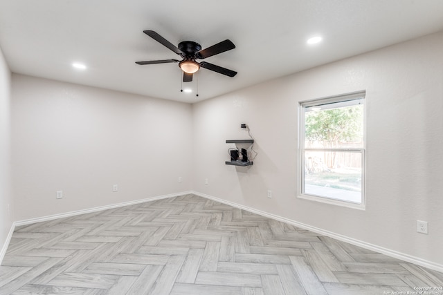 empty room with light parquet flooring and ceiling fan