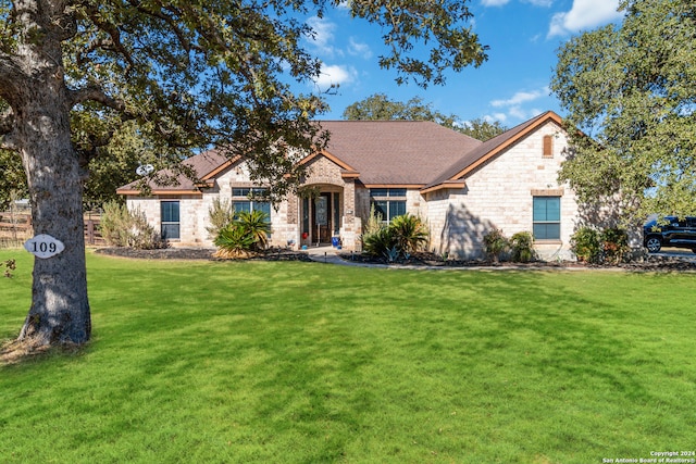 ranch-style house featuring a front lawn