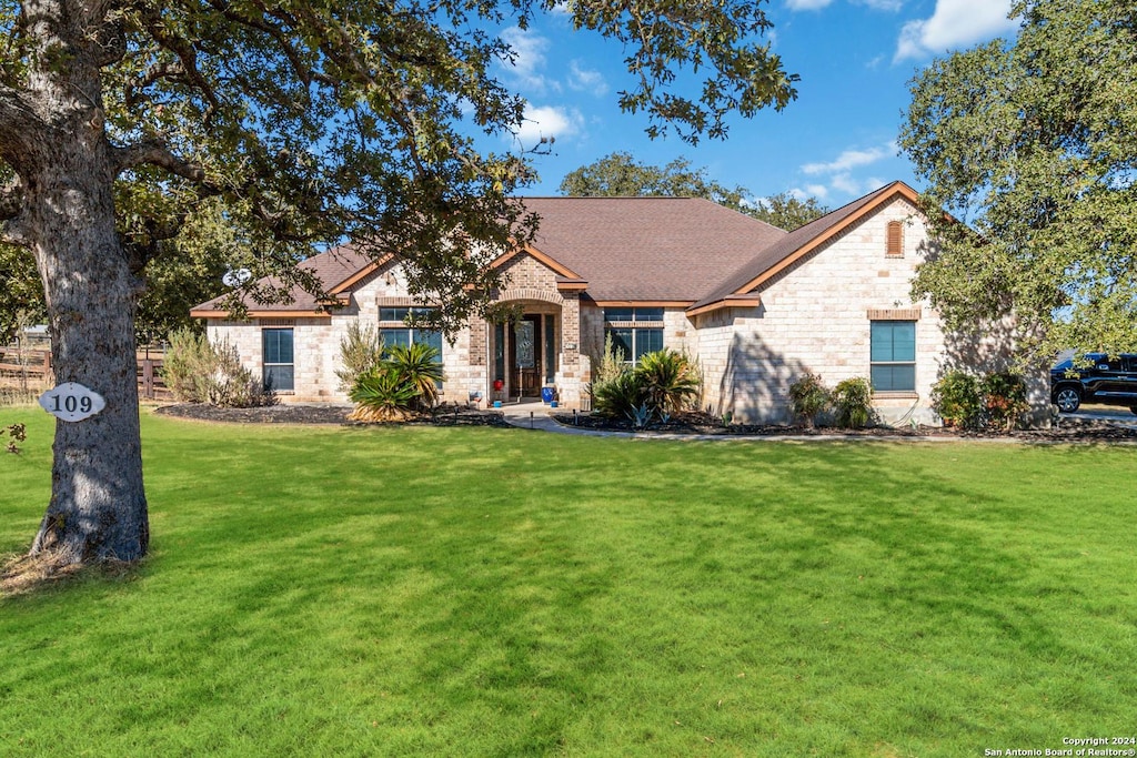 view of front of property featuring a front yard and stone siding