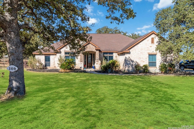 view of front of property featuring a front yard and stone siding