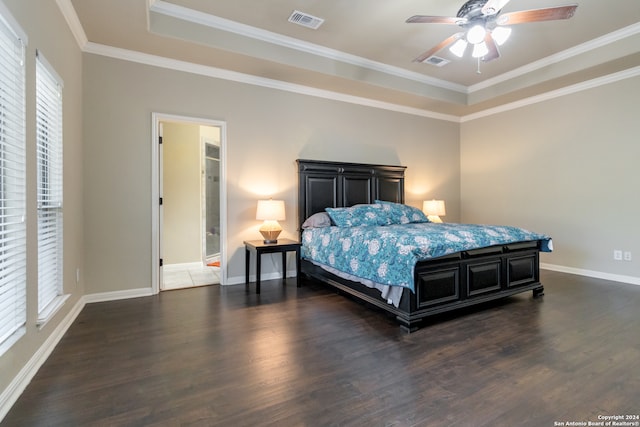 bedroom with ornamental molding, ceiling fan, ensuite bath, and dark hardwood / wood-style flooring