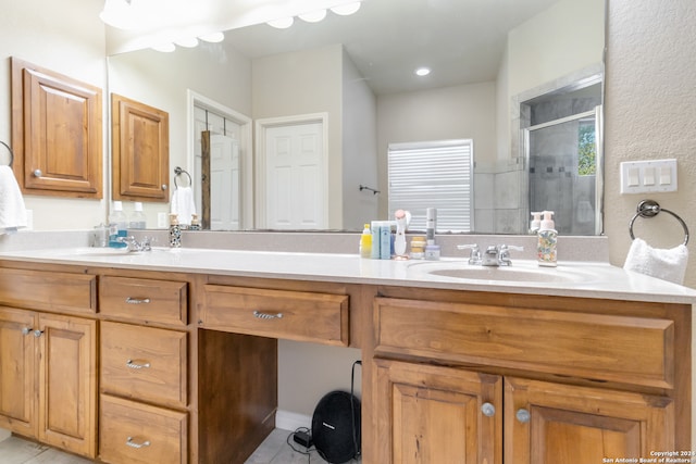 bathroom featuring vanity and a shower with shower door