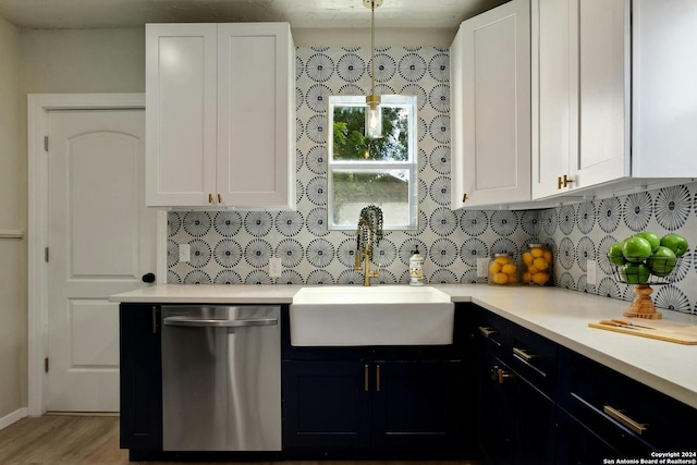 kitchen with white cabinets, hanging light fixtures, stainless steel dishwasher, and sink