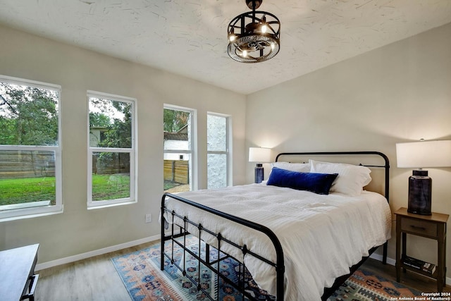 bedroom with a textured ceiling and hardwood / wood-style floors