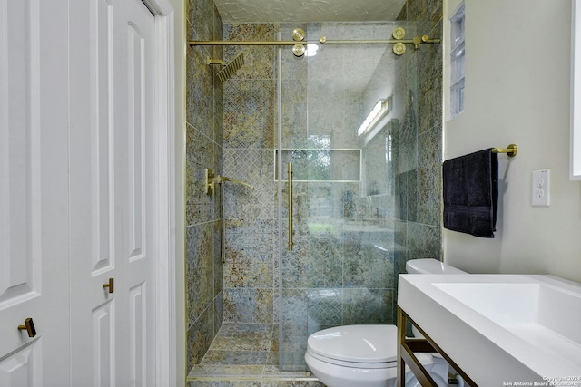 bathroom featuring a stall shower, vanity, and toilet