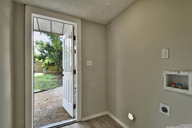 entryway with baseboards and wood finished floors