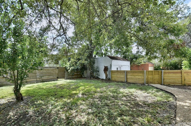 view of yard featuring a fenced backyard and a gate