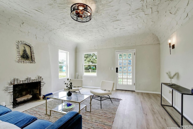 living room with light hardwood / wood-style flooring and vaulted ceiling