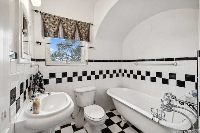 bathroom featuring tile walls, a bathtub, and toilet