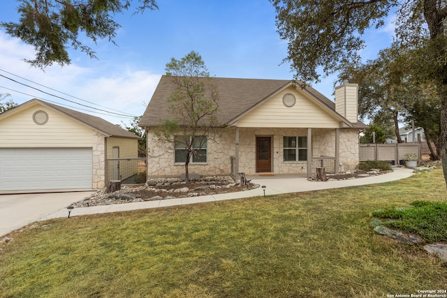 view of front facade featuring a porch, a front lawn, and a garage