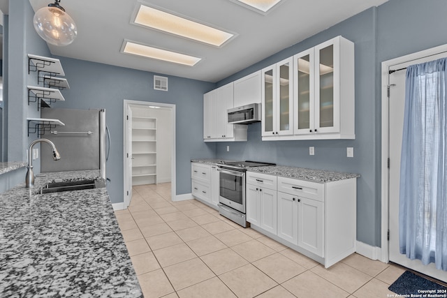 kitchen featuring white cabinetry, light stone countertops, stainless steel appliances, and sink