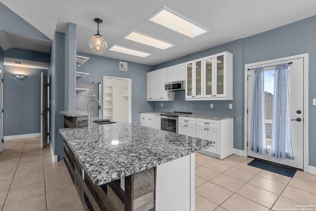 kitchen featuring appliances with stainless steel finishes, a kitchen breakfast bar, white cabinetry, pendant lighting, and light stone counters