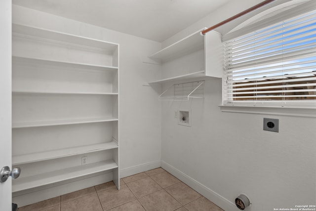 laundry area featuring hookup for a washing machine, electric dryer hookup, and light tile patterned flooring