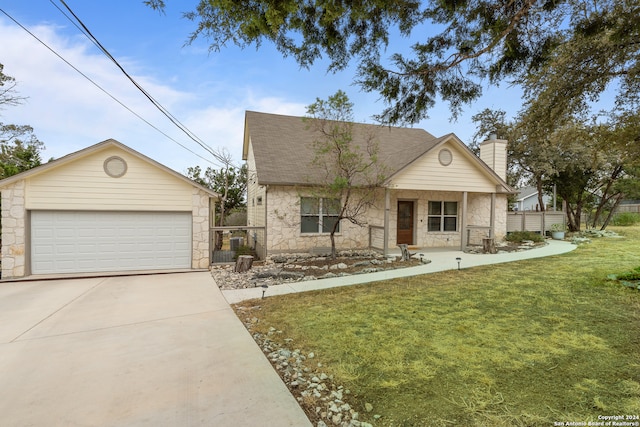 view of front of property featuring a front yard, a porch, and a garage