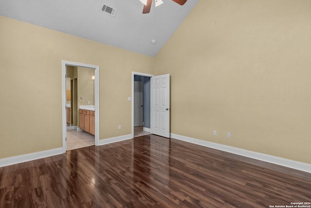 unfurnished bedroom with connected bathroom, ceiling fan, high vaulted ceiling, and light hardwood / wood-style flooring