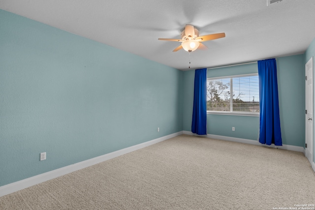 carpeted empty room with a textured ceiling and ceiling fan