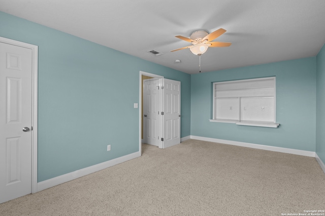 unfurnished bedroom with light carpet and ceiling fan