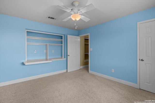 unfurnished bedroom featuring ceiling fan and light carpet