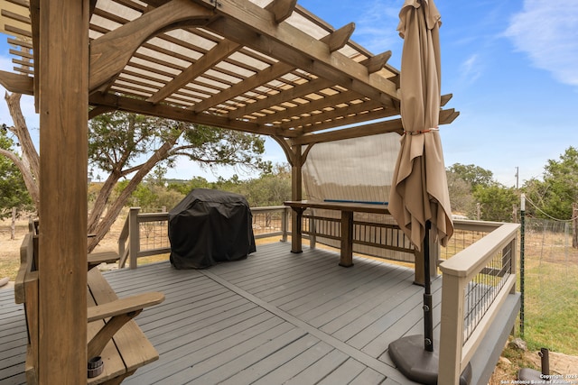 wooden terrace with a grill and a pergola