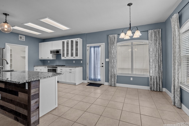 kitchen featuring pendant lighting, stone countertops, white cabinetry, and stainless steel appliances