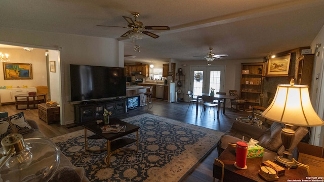 living room featuring hardwood / wood-style flooring and ceiling fan with notable chandelier