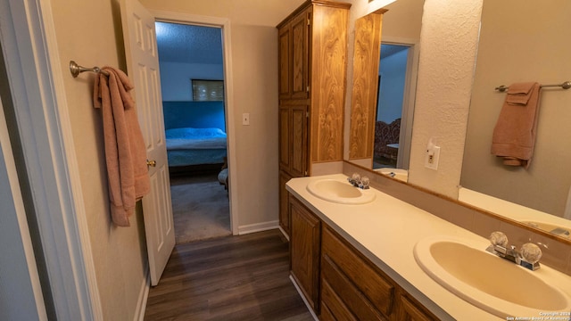 bathroom featuring vanity, a textured ceiling, and wood-type flooring