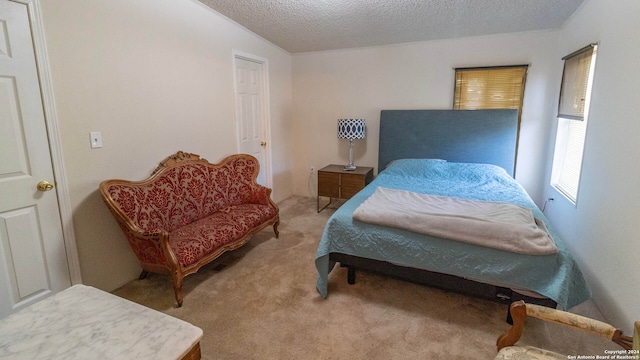 bedroom with a textured ceiling, light colored carpet, and vaulted ceiling