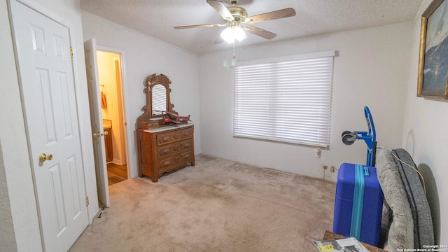 miscellaneous room featuring a textured ceiling, light colored carpet, and ceiling fan