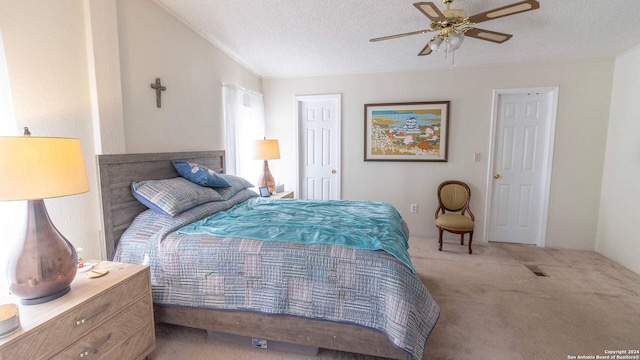 carpeted bedroom with ceiling fan, a textured ceiling, and lofted ceiling