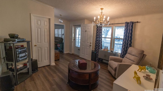 living room featuring a textured ceiling, dark hardwood / wood-style floors, and a chandelier