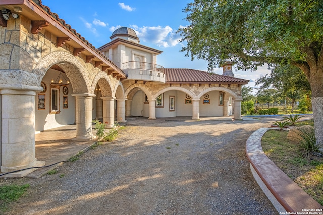 mediterranean / spanish house featuring a balcony