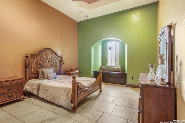 bedroom featuring high vaulted ceiling