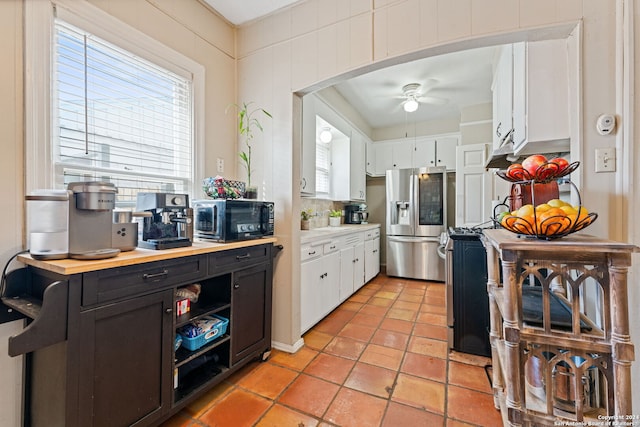 kitchen with white cabinetry, ceiling fan, and stainless steel appliances