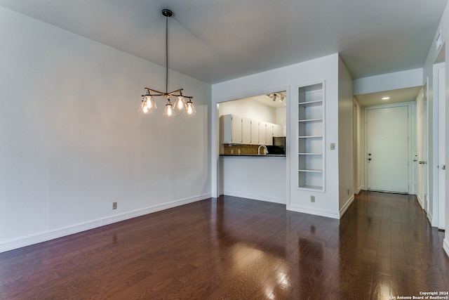 interior space featuring dark hardwood / wood-style floors and built in shelves