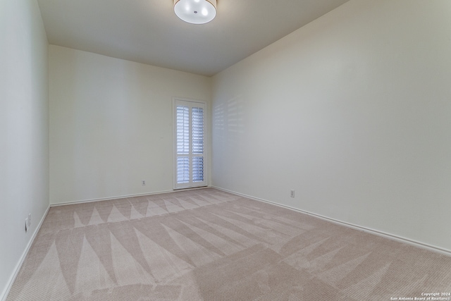 spare room with light carpet