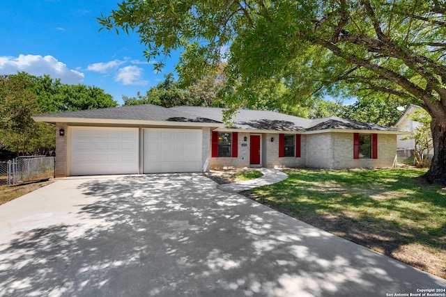 single story home with a front yard and a garage