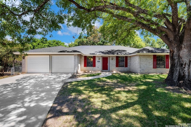 single story home with a front yard and a garage