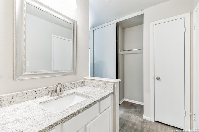 bathroom featuring vanity and hardwood / wood-style flooring