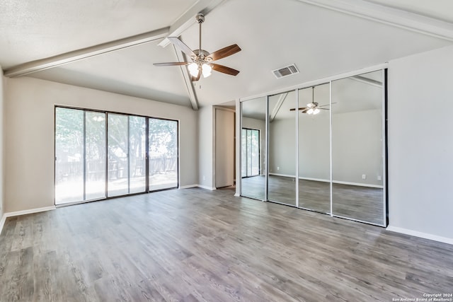 interior space with hardwood / wood-style flooring, lofted ceiling with beams, access to outside, and ceiling fan