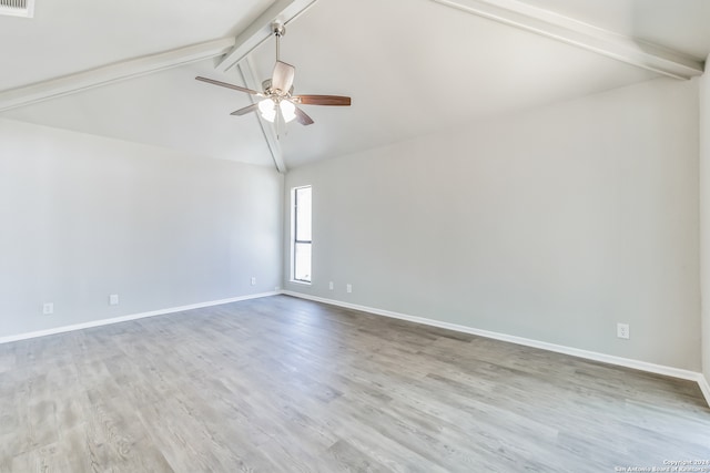 unfurnished room featuring ceiling fan, light hardwood / wood-style flooring, and vaulted ceiling with beams