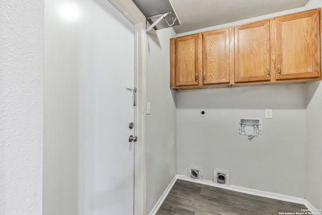 laundry room with dark wood-type flooring, electric dryer hookup, washer hookup, and cabinets