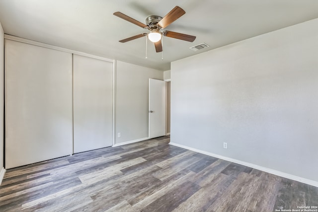 unfurnished bedroom with hardwood / wood-style flooring, a closet, and ceiling fan