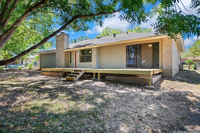 rear view of house featuring a deck