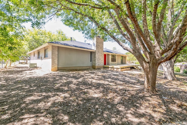 back of property with central AC and a wooden deck