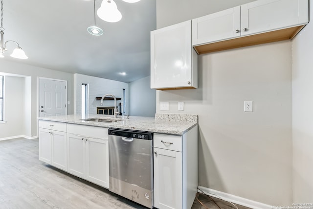 kitchen featuring white cabinetry, stainless steel dishwasher, hanging light fixtures, and sink