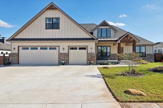 craftsman-style house with a garage and a front lawn